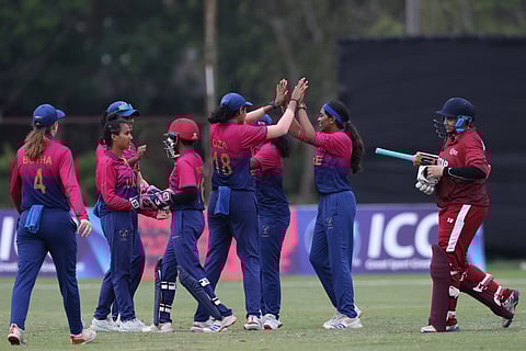 UAE women's team celebrate a wicket in the rain-hit match against Qatar in Bangkok on Saturday.