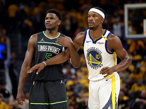 Anthony Edwards #5 of the Minnesota Timberwolves and Jimmy Butler III #10 of the Golden State Warriors look on during the fourth quarter in Game Three of the Western Conference Second Round NBA Playoffs at Chase Center on May 10, 2025 in San Francisco, California.