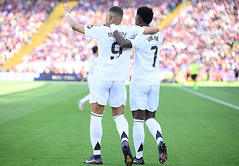 Real Madrid's French forward #09 Kylian Mbappe (L) celebrates with Real Madrid's Brazilian forward #07 Vinicius Junior after scoring their second goal during the Spanish league football match between FC Barcelona and Real Madrid CF at Estadi Olimpic Lluis Companys in Barcelona, on May 11, 2025.