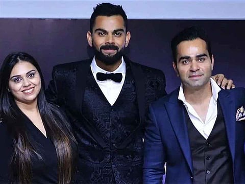 Virat Kohli with his sister Bhawna Kohli Dhingra (left) and brother Vikas Kohli (right).