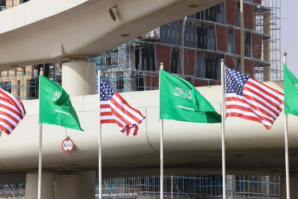 Saudi and US flags flutter in front of a building under construction on a main road in Riyadh on May 12, 2025, hours before of a visit by US President Donald Trump to the kingdom.  
