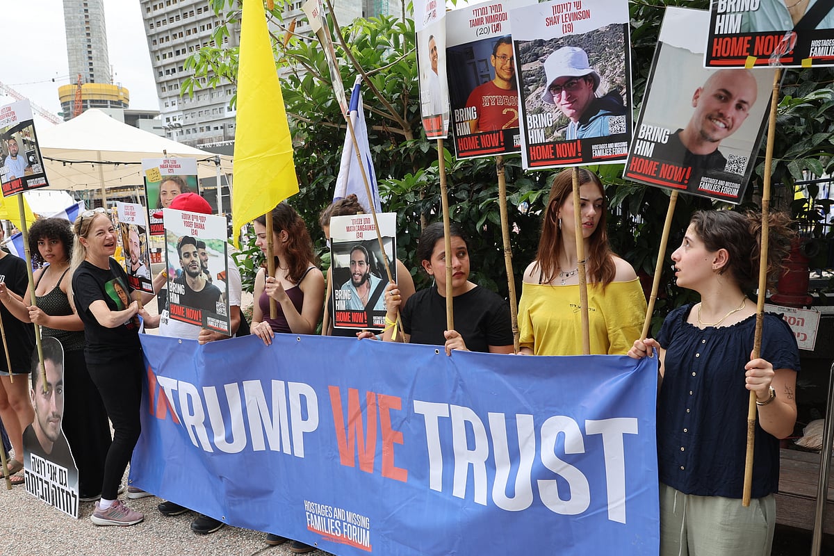 People hold placards with images of hostages held in Gaza since October 2023 on the day US special envoy to the Middle East, Steve Witkof, is expected to visit the Hostages Square in Tel Aviv, on May 13, 2025, less than 24 hours since Edan Alexander, a US-Israeli soldier freed by Palestinian militant group Hamas after 584 days in captivity was reunited with his family in Israel.