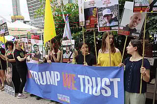 People hold placards with images of hostages held in Gaza since October 2023 on the day US special envoy to the Middle East, Steve Witkof, is expected to visit the Hostages Square in Tel Aviv, on May 13, 2025, less than 24 hours since Edan Alexander, a US-Israeli soldier freed by Palestinian militant group Hamas after 584 days in captivity was reunited with his family in Israel.