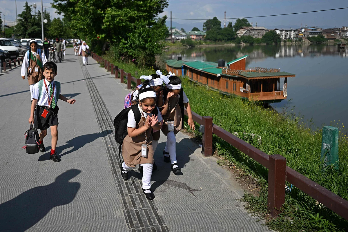 Students walk to attend classes after their school reopened in Srinagar on May 13, 2025. 