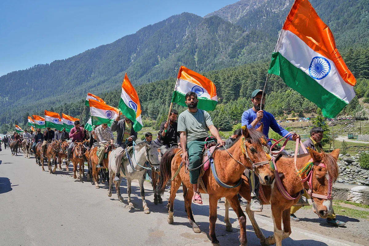 Hoteliers, pony riders and tour guides carrying Indian national flags shout pro India slogans during a Tiranga Yatra or tricolor march to highlight the success of Indian military Operation Sindoor, in Pahalgam in Indian administered Kashmir on May 15, 2025.  