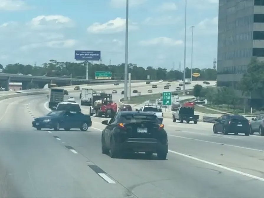 The car was towed backward at high speed on the highway, zigzagging wildly with a panicked driver inside
