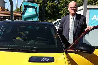 France's Minister for Economy, Finances and Industrial and Digital sovereignty Eric Lombard stands next to an electric car on a Carrefour supermarket parking lot during a visit dedicated to electric vehicle charging stations, in l'Hay-les-Roses, outside Paris. File photo taken on May 16, 2025.