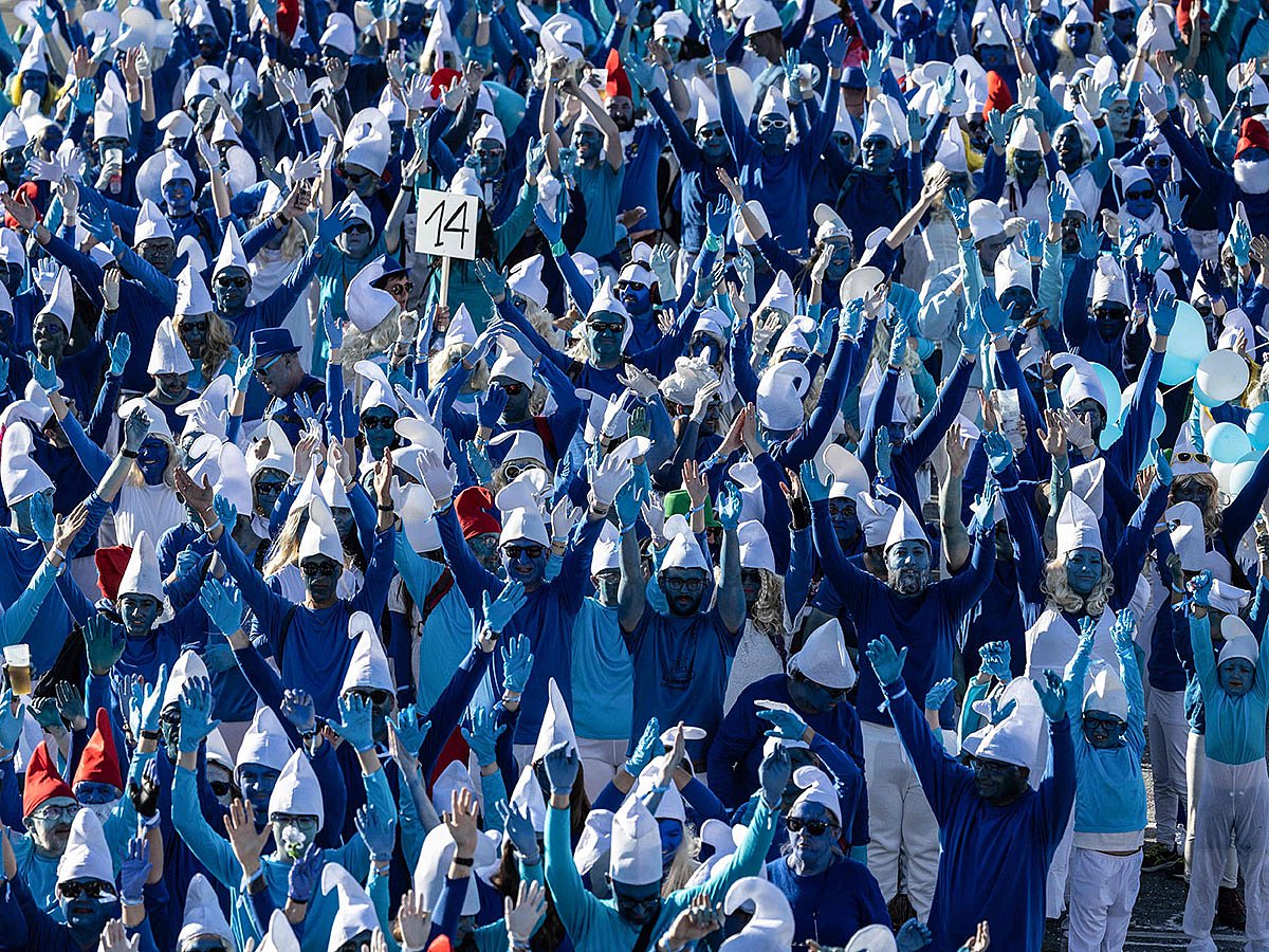 Participants wearing smurf (schtroumpf) costumes take part in an attempt to break the world record for the largest gathering of smurfs, in Landerneau, western France.