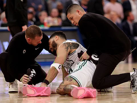 Jayson Tatum #0 of the Boston Celtics is looked over on the court after being injured against the New York Knicks during the fourth quarter in Game Four of the Eastern Conference Second Round NBA Playoffs at Madison Square Garden on May 12, 2025 in New York City.