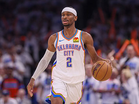 Oklahoma City Thunder guard Shai Gilgeous-Alexander dribbles the ball up court against Minnesota Timberwolves during the second half of Game 1 of an NBA basketball Western Conference Finals playoff series in Oklahoma City.