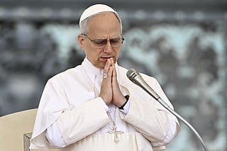 Pope Leo XIV prays at the end of his first weekly general audience at St Peter's Square in The Vatican on May 21, 2025.