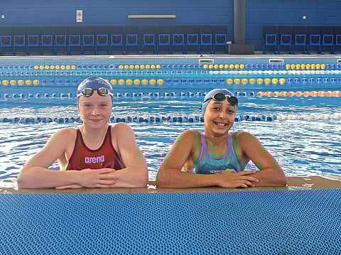 Aya Al Dameh (right), who won two gold and a bronze medal, with teammate Annie Gardiner, who bagged a bronze, at the World School Games Swim Championships in UK