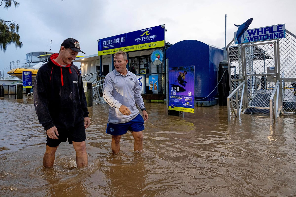 Conor Lang and Anthony Heeney walk through flooded areas in Port Macquarie, north of Sydney, Australia, Wednesday, May 21.