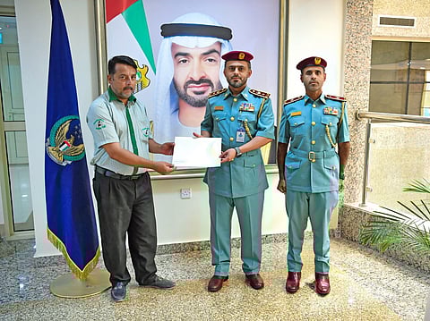 Ajman Police honour taxi driver Shah Omar for his heroic act .
