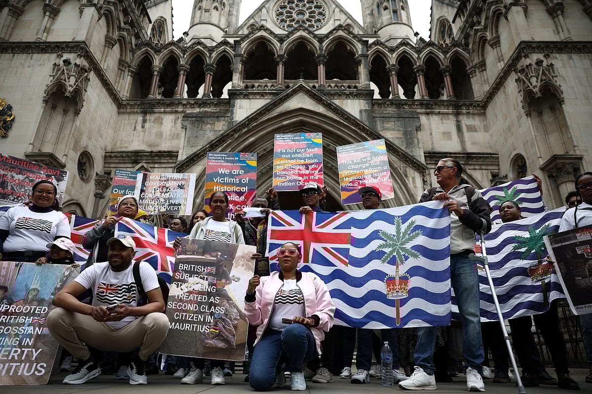 Members of the Chagossian community and supporters pose for a photo outside the High Court in London on May 22, 2025.