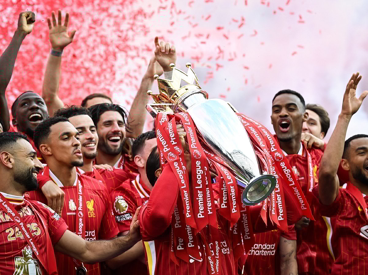 Liverpool players celebrate with the Premier League trophy at Anfield on Sunday.