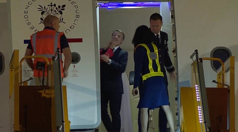 In this grab taken from video, a hand shoves France's President Emmanuel Macron's face away as he prepares to disembark a plane on arrival, in Hanoi, Vietnam, Sunday, May 25, 2025.