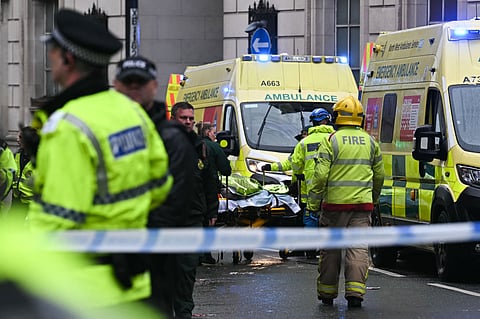 A person is evacuated on a stretcher as police and ambulance gather on the scene of an incident in Water Street, on the sidelines of an open-top bus victory parade for Liverpool's Premier League title win, in Liverpool, north-west England on May 26, 2025