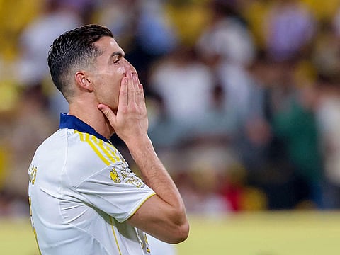 Nassr's Portuguese forward Cristiano Ronaldo vies for the ball with Khaleej's Saudi midfielder  Khaled al-Samiri during the Saudi Pro League football match between Al-Nassr and Al-Khaleej at Al-Awwal Park in Riyadh on May 21, 2025.