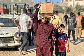 Displaced Palestinians receive food packages from a US-backed foundation pledging to distribute humanitarian aid in western Rafah in the southern Gaza Strip.