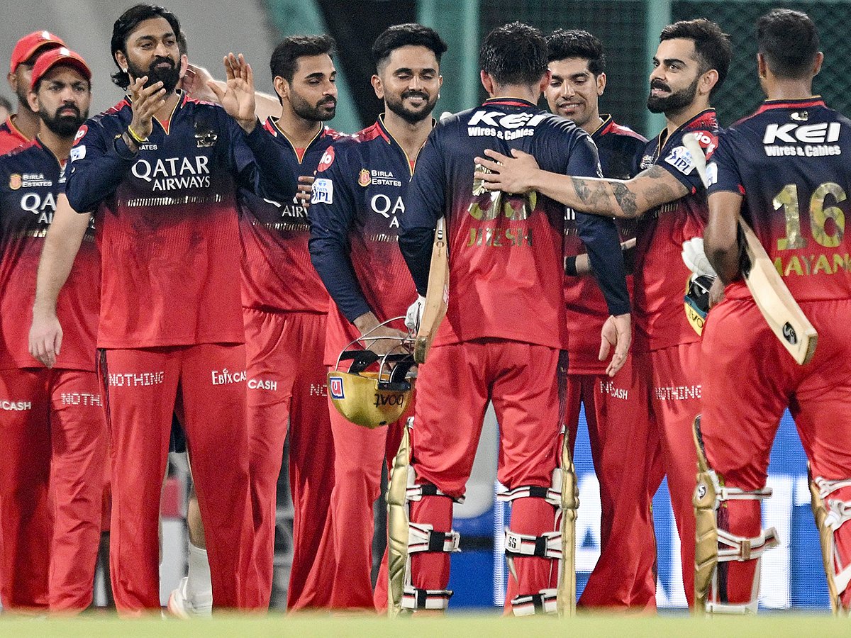 Royal Challengers Bengaluru's captain Jitesh Sharma (4R) is congratulated by teamates for his innings as they celebrate their team's win against Lucknow Super Giants at the end of their IPL match in the Ekana Cricket Stadium of Lucknow on May 27, 2025. 