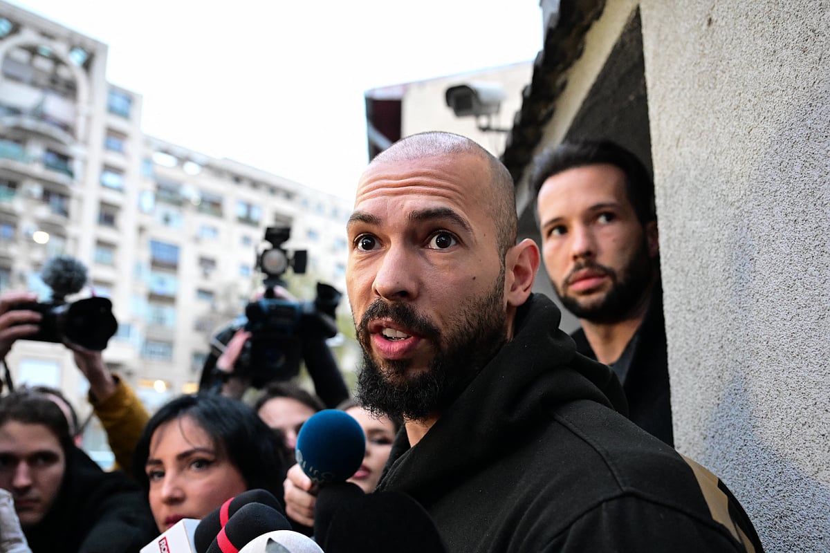 Andrew Tate (C) and his brother Tristan Tate (R) speak to journalists after having been released from detention in Bucharest, Romania on March 12, 2024.