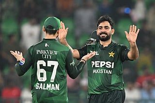 Pakistan's Khushdil Shah (R) celebrates with Salman Ali Agha (L) after taking the wicket of Bangladesh's Towhid Hridoy (not pictured) during the first Twenty20 international cricket match between Pakistan and Bangladesh at the Gaddafi Cricket Stadium in Lahore on May 28, 2025.