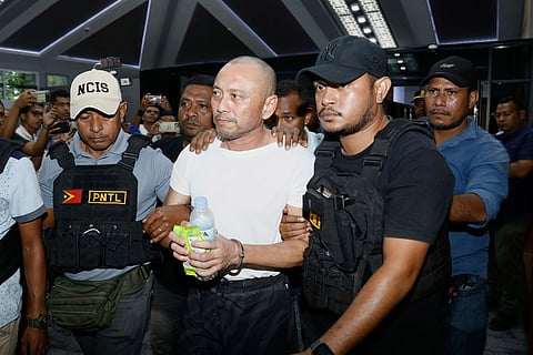 A former Filipino Congressman charged with multiple murders in the Philippines, Arnolfo Teves Jr, center, is escorted by police officers in Dili, East Timor, Thursday, May 29, 2025.  