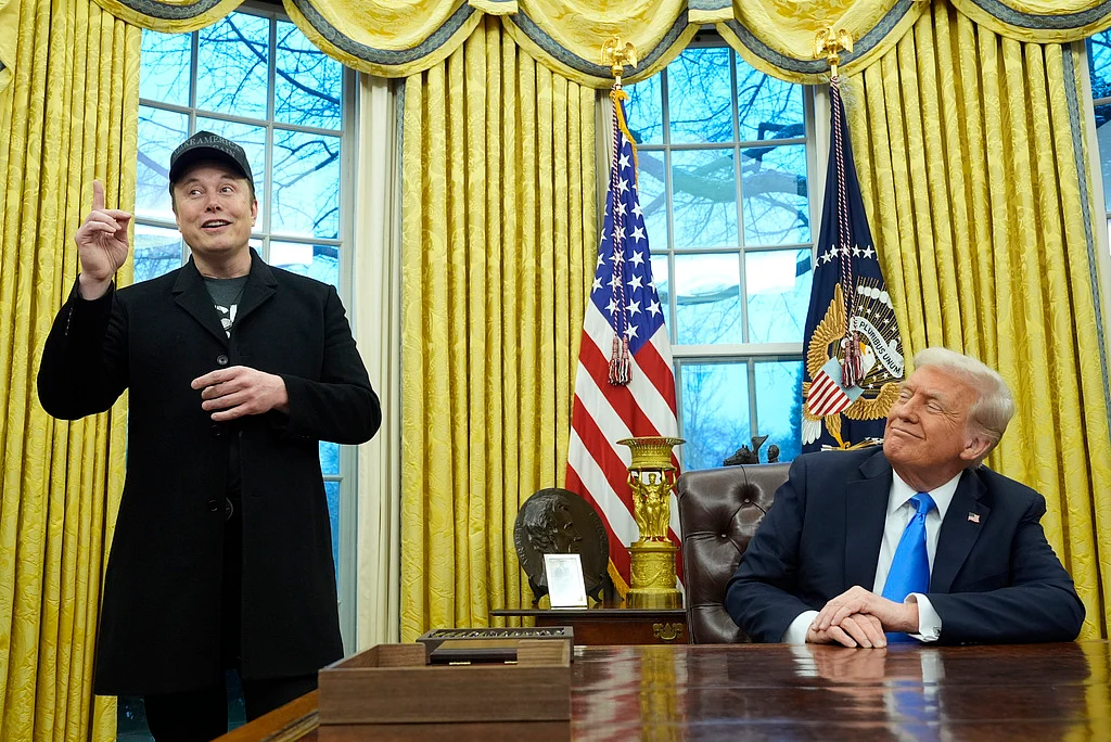 President Donald Trump listens as Elon Musk speaks in the Oval Office at the White House, Feb. 11, 2025, in Washington. 