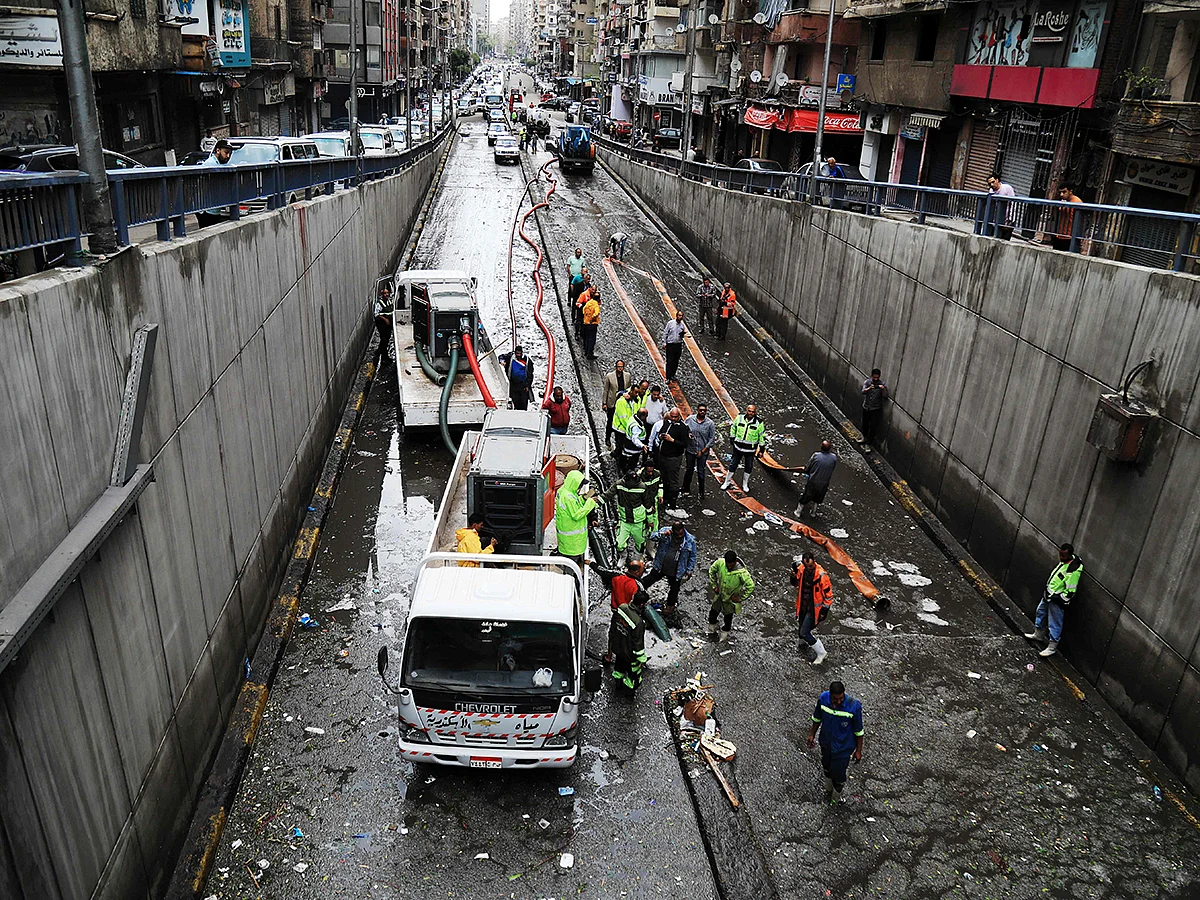Municipal emergency service staff clear hail blocking an underpass after a windstorm struck Egypt's northern city of Alexandria on the Mediterranean coast in the early hours on May 31, 2025. 