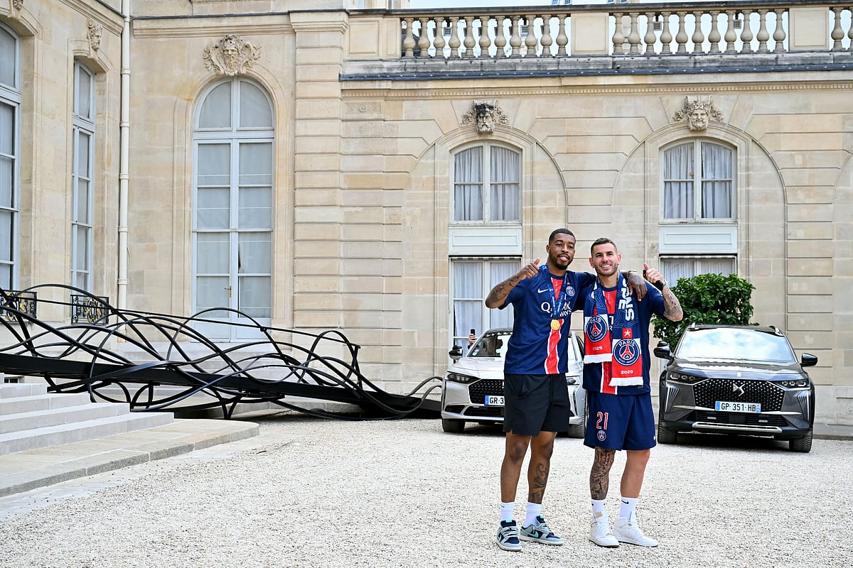 Paris Saint-Germain's French defender Presnel Kimpembe (L) and French defender Lucas Hernandez thumb up as they leave after a reception at the Elysee presidential palace in Paris on June 1, 2025.