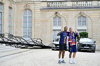 Paris Saint-Germain's French defender Presnel Kimpembe (L) and French defender Lucas Hernandez thumb up as they leave after a reception at the Elysee presidential palace in Paris on June 1, 2025.