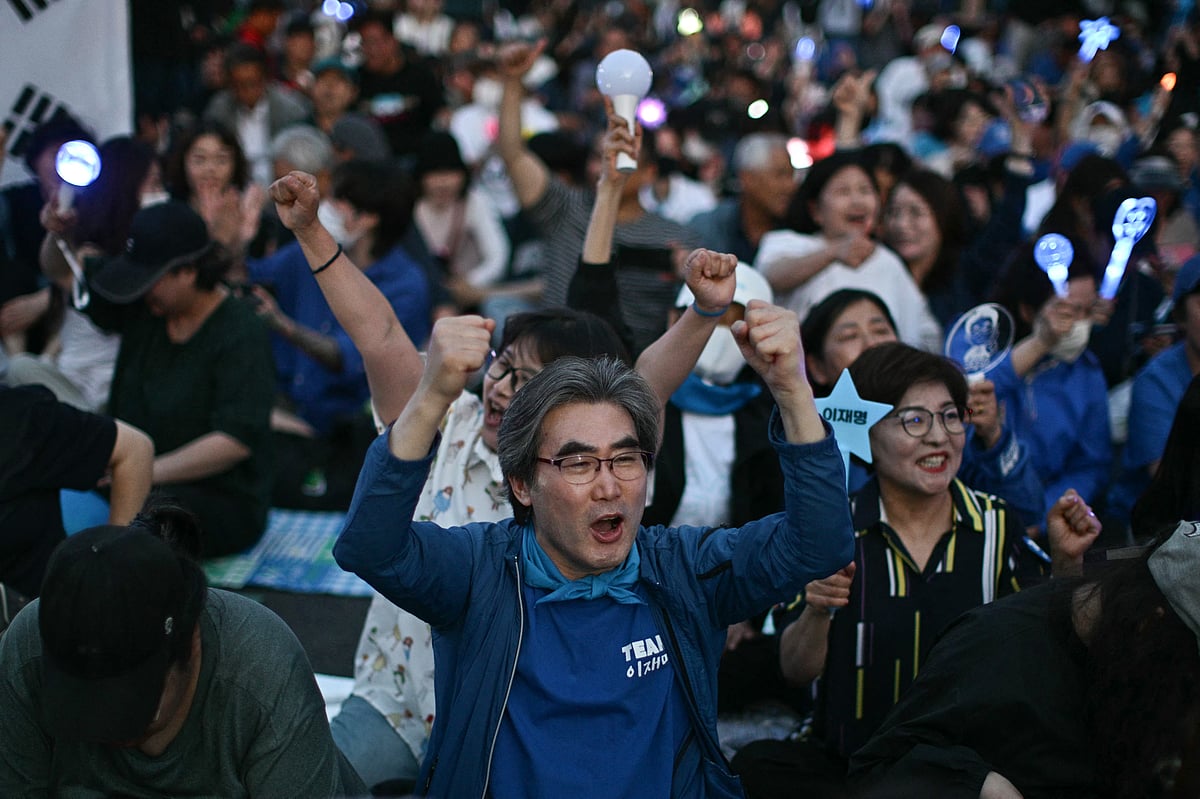 People celebrate after exit polls show South Korea's Lee Jae-myung of the left-leaning Democratic Party appears on track to win the presidential election in Seoul on June 3, 2025.
