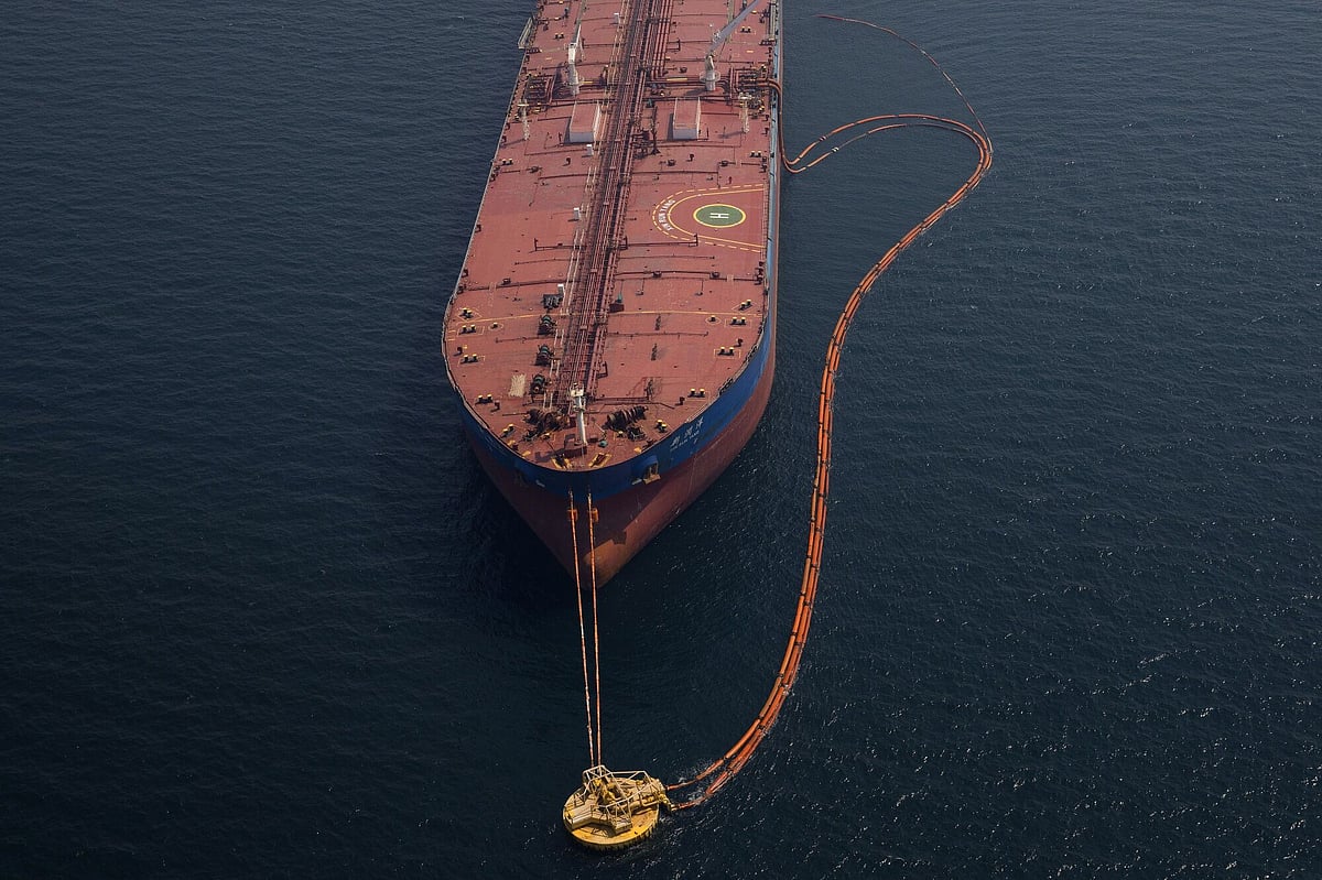 Pipes feed crude oil to a tanker.
