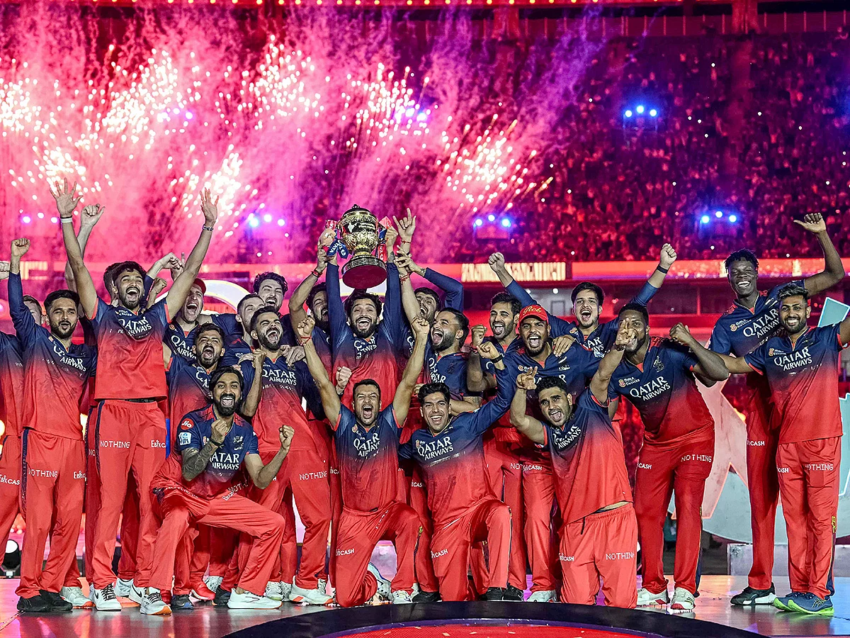 Royal Challengers Bengaluru's players celebrate with the trophy after winning the Indian Premier League against Punjab Kings on Tuesday.