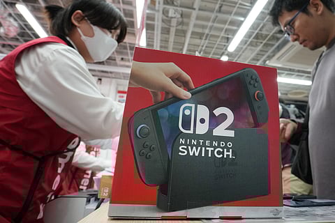 Darrell Zimmer purchases a Nintendo's Switch 2 console at a midnight opening of a Best Buy store on June 05, 2025 in Pembroke Pines, Florida.