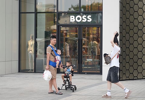 A family shopping at a shopping mall in Hanoi, Vietnam, Wednesday, June 4, 2025.  