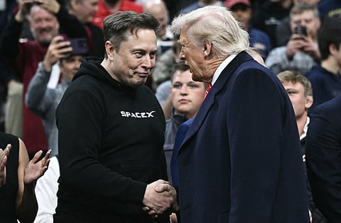 Tesla and SpaceX CEO Elon Musk (L) and US President Donald Trump shake hands as they attend the men's NCAA wrestling competition at the Wells Fargo Center in Philadelphia, Pennsylvania, on March 22, 2025.