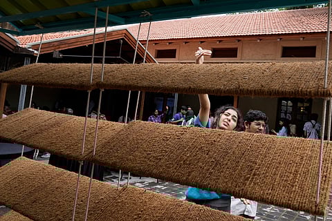 Ankritya Diggavi, one of the architects behind the design of Neralu, an innovative portable heat shelter, explains its features to visitors at the Sweat and Concrete 2025 event in Bengaluru, India, Thursday, May 29, 2025. 