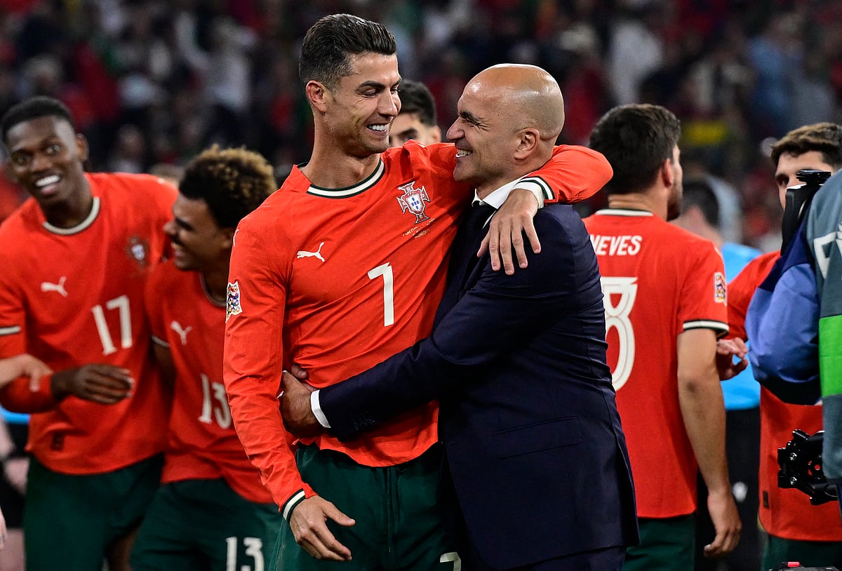 Portugal's forward #07 Cristiano Ronaldo and Portugal's Spanish head coach Roberto Martinez celebrate winning the UEFA Nations League final football match between Portugal and Spain in Munich, southern Germany on June 8, 2025.