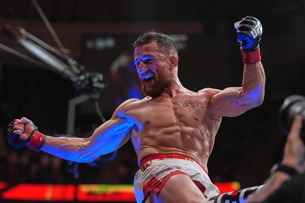 Georgia's Merab Dvalishvili celebrates after winning his bantamweight title bout against Sean O'Malley at the UFC 316 mixed martial arts event Sunday, June 8, 2025 in Newark, N.J. 