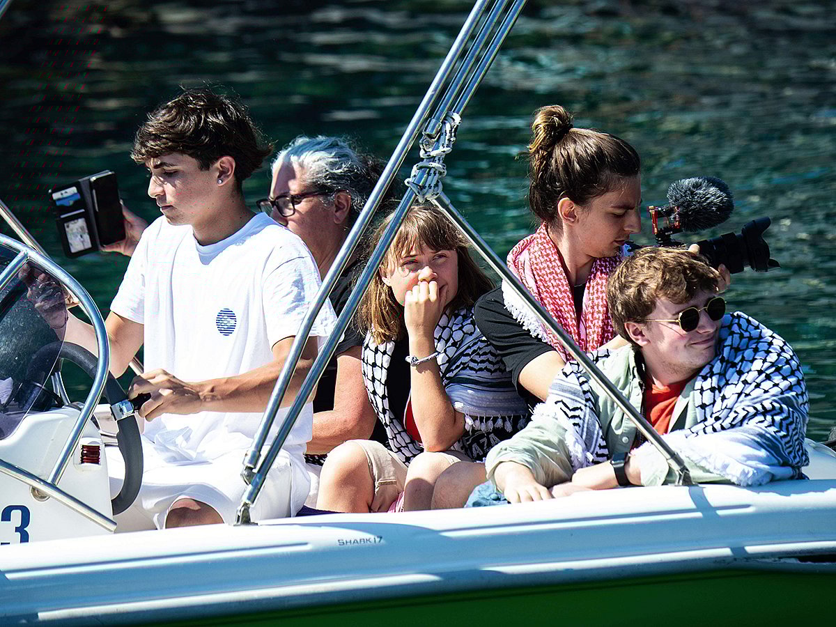 Climate activist Greta Thunberg, center, waits to board the Madleen boat, before setting sail for Gaza along with activists of the Freedom Flotilla Coalition, departing from the Sicilian port of Catania, Italy, Sunday, June 1, 2025. 