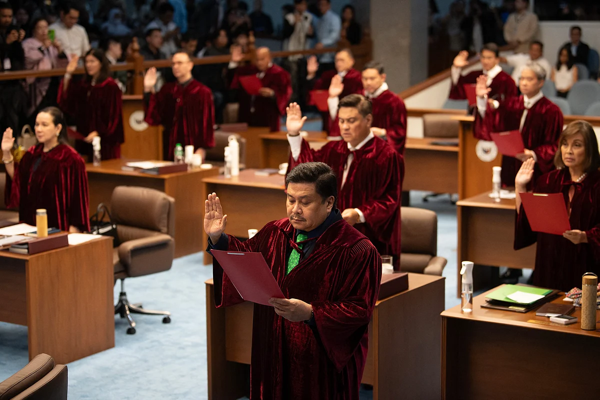 Philippine senators take their oath as jurors in the impeachment trial of Vice President Sara Duterte, with the newly convened court moving to immediately hear a motion to dismiss the case, in Manila on June 10, 2025.