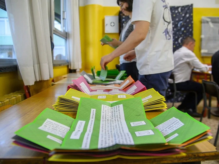 Ballot papers are prepared on a table for referendums on citizenship and job protections, at a polling station in Milan, Italy.