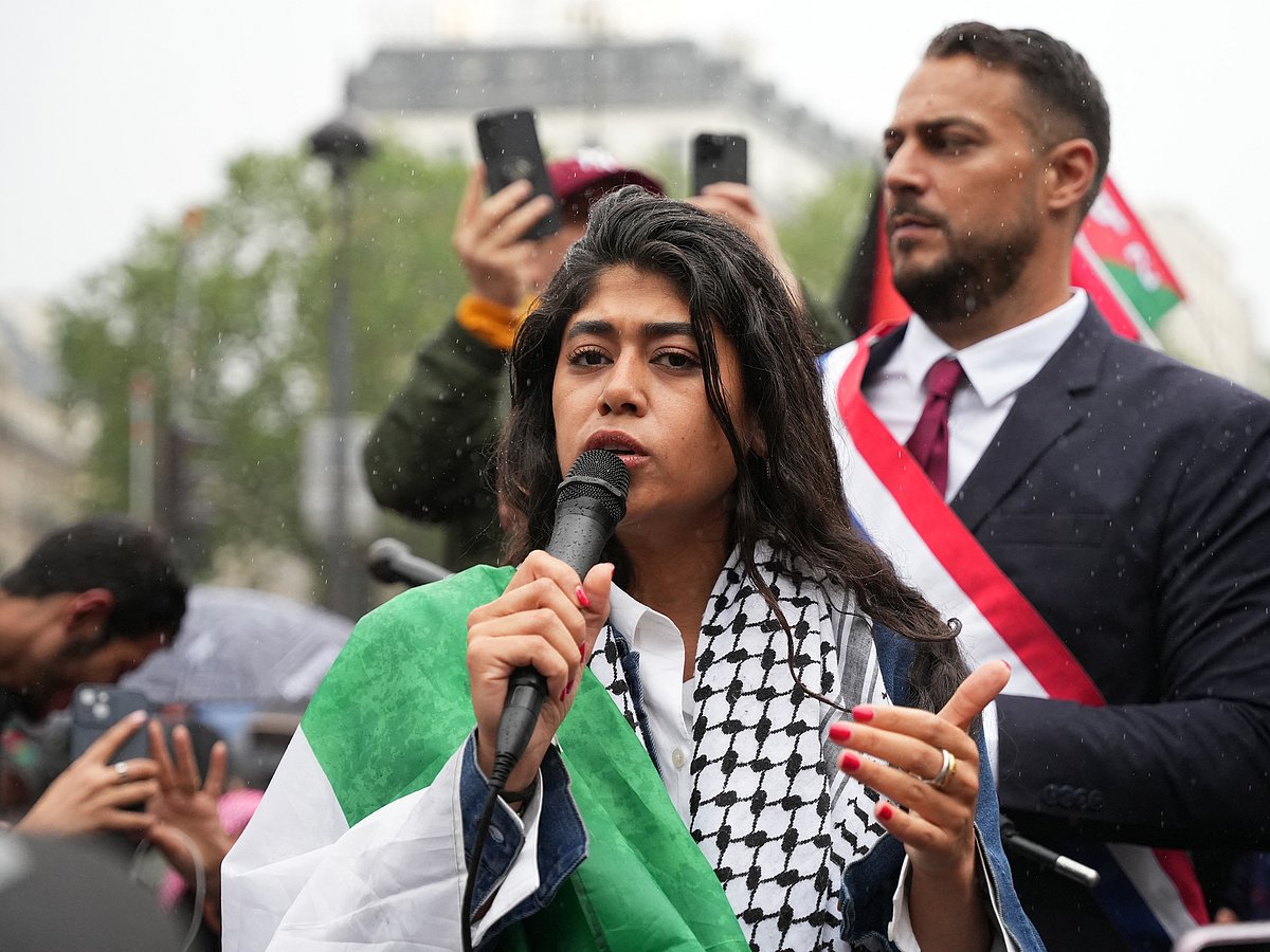 Rima Hassan addressing a rally in Paris to protest against the killings in Gaza.