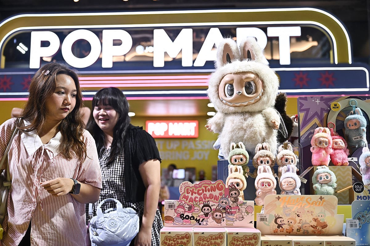 People look at collectable designer art toy Labubu at a Pop Mart pop-up store in Siam Center shopping mall in Bangkok on May 6, 2025.