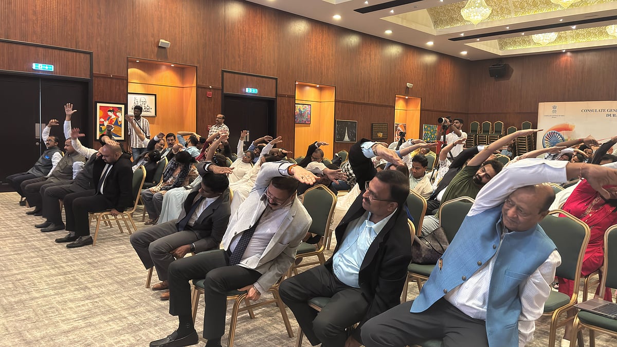 Community leaders, yoga enthusiasts and members of the media take part in a chair yoga session held as part of the Yoga Day curtain raiser event at the Indian Consulate in Dubai on Thursday. 