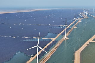 Solar panels and wind turbines are seen at the Huaneng Binzhou new energy power generation project in Binzhou, in China’s eastern Shandong province on June 11, 2025.