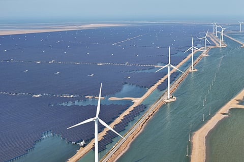 Solar panels and wind turbines are seen at the Huaneng Binzhou new energy power generation project in Binzhou, in China’s eastern Shandong province on June 11, 2025.