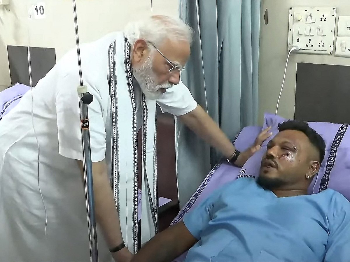 India's Prime Minister Narendra Modi meeting with Vishwash Kumar Ramesh, sole survivor of the Air India flight 171 crash, at a hospital in Ahmedabad. Rescue teams with sniffer dogs combed the crash site on June 13 of the London-bound passenger jet which ploughed into a residential area of India's Ahmedabad city, killing at least 265 people on board and on the ground. 